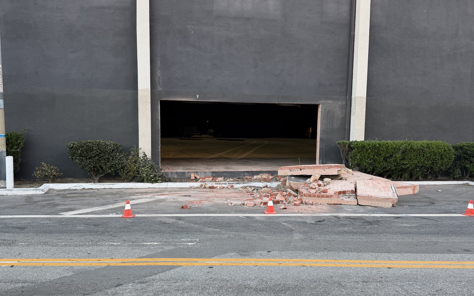 New pedestrian opening cut through the warehouse wall, cut panel broken out on the ground