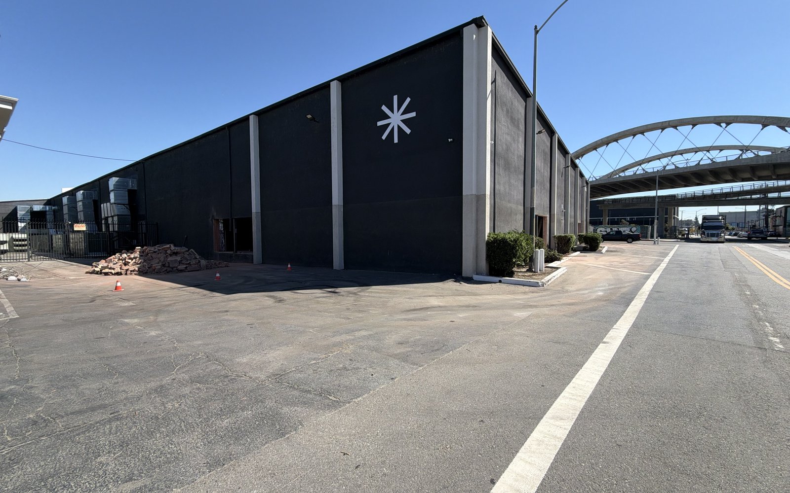 Wide view of the warehouse with the Bobcat and cut concrete out front